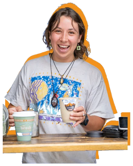 A barista handing over a Colorado Cup